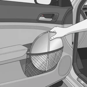 A folded collapsible auto sun shades tucked neatly into a car door pocket or glove compartment for easy storage.