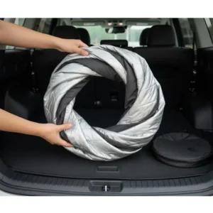A person folding a flexible hyundai palisade sun shade into a small circle for storage.