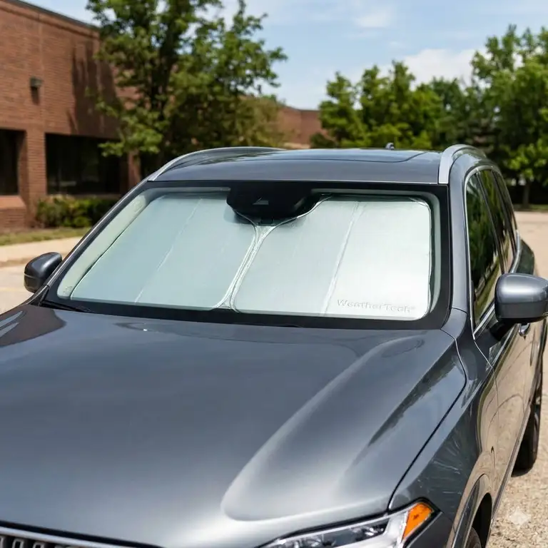 A detailed weathertech sun shade review featuring a custom-fit windshield protector installed in a car.