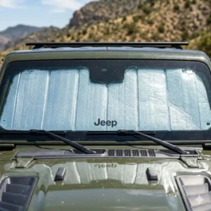 Close-up of the reflective surface of a windshield sun shade jeep wrangler blocking intense desert heat.